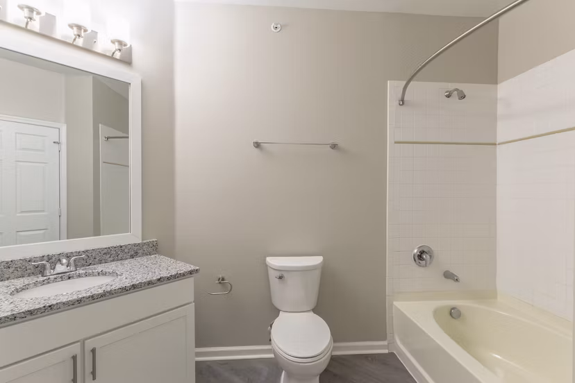 Bathroom featuring modern fixtures and granite countertops in Nav850 Apartments