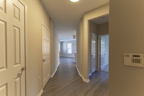 Contemporary hallway featuring modern lighting and artwork at Nav850 Apartments