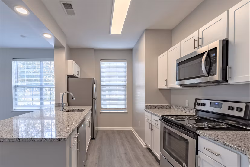 Modern kitchen with stainless steel appliances at Nav850 Apartments, offering luxury living in a Greystar community