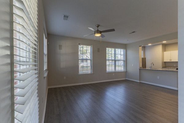 Contemporary living room with sleek furniture and large windows in Nav850 Apartments