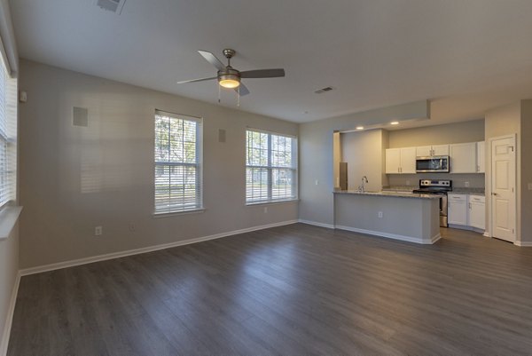 Modern living room with stylish decor and large windows at Nav850 Apartments, offering luxury living in a prime location