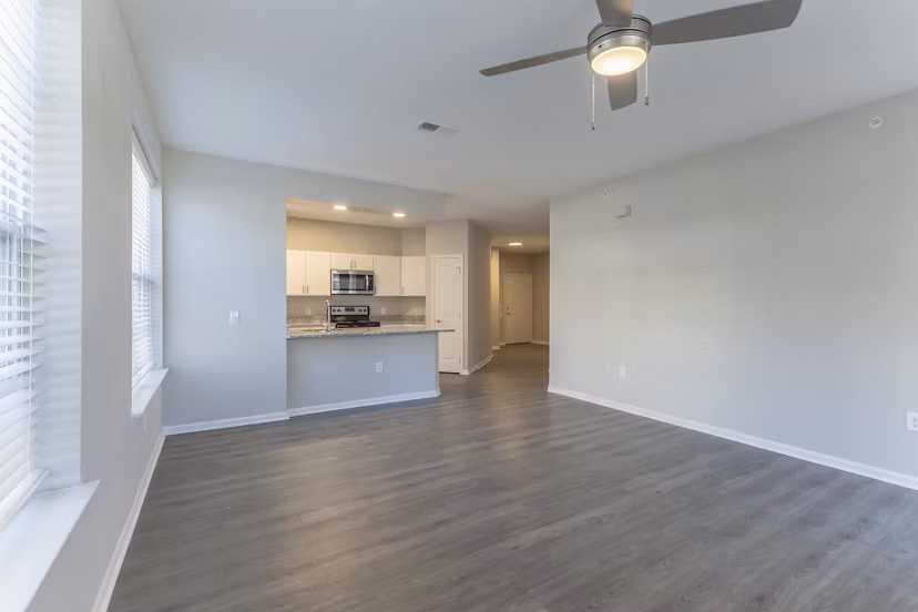 Spacious living room with modern decor and ample lighting in Nav850 Apartments