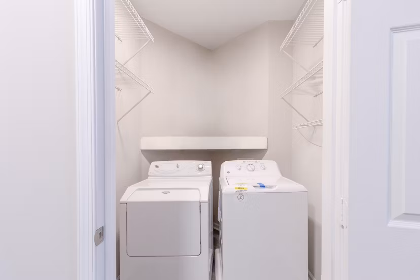 Laundry room with modern appliances in Nav850 Apartments
