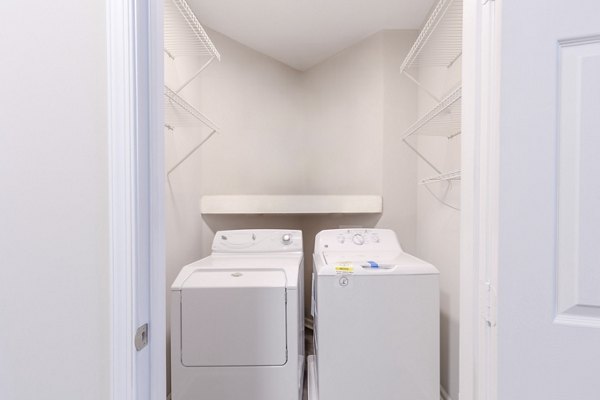 Laundry room with modern appliances in Nav850 Apartments