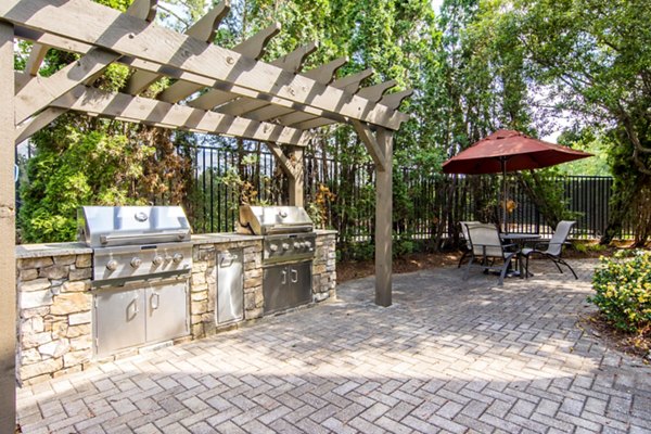 Charming outdoor patio at Aventura Decatur Apartments featuring cozy seating and lush greenery, ideal for relaxation and social gatherings
