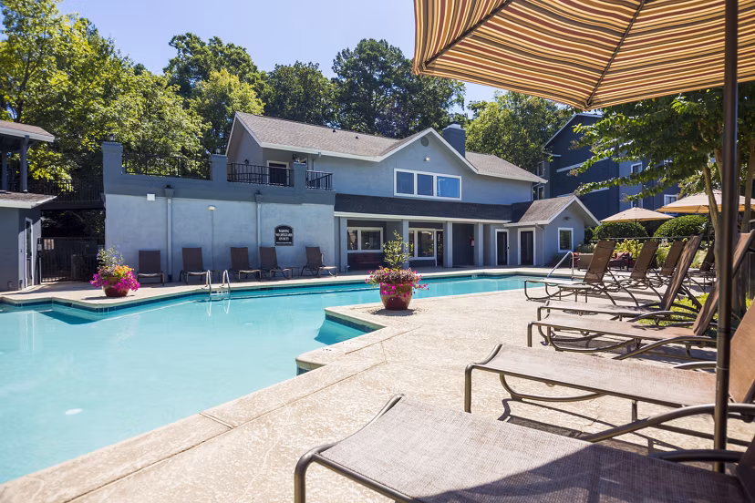 Rooftop pool with lounge chairs at Aventura Dunwoody Apartments