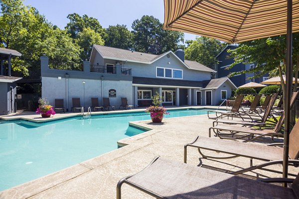 Rooftop pool with lounge chairs at Aventura Dunwoody Apartments