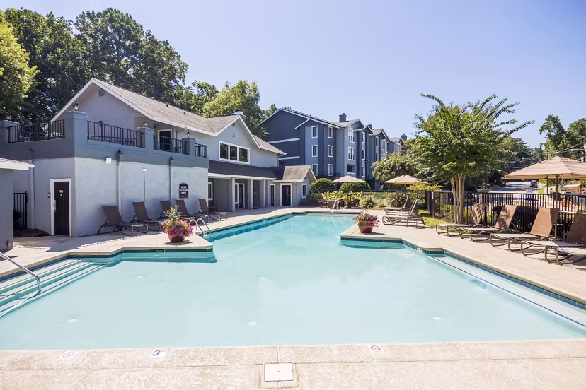 Resort-style pool with sun loungers at Aventura Dunwoody Apartments, offering a relaxing retreat in a vibrant community