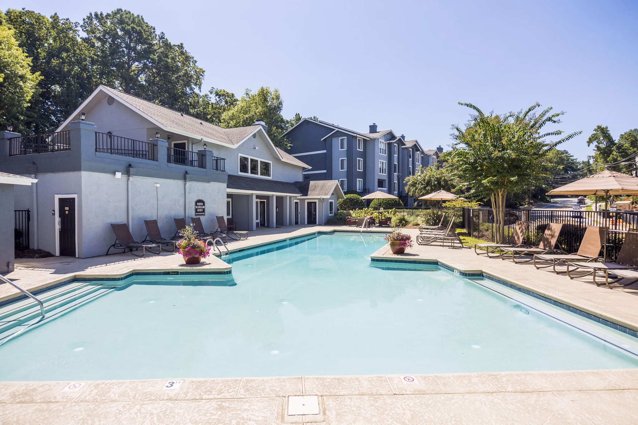 Resort-style pool with sun loungers at Aventura Dunwoody Apartments, offering a relaxing retreat in a vibrant community