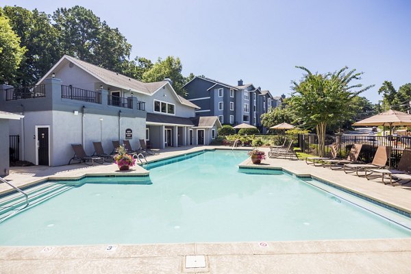 Resort-style pool with sun loungers at Aventura Dunwoody Apartments, offering a relaxing retreat in a vibrant community