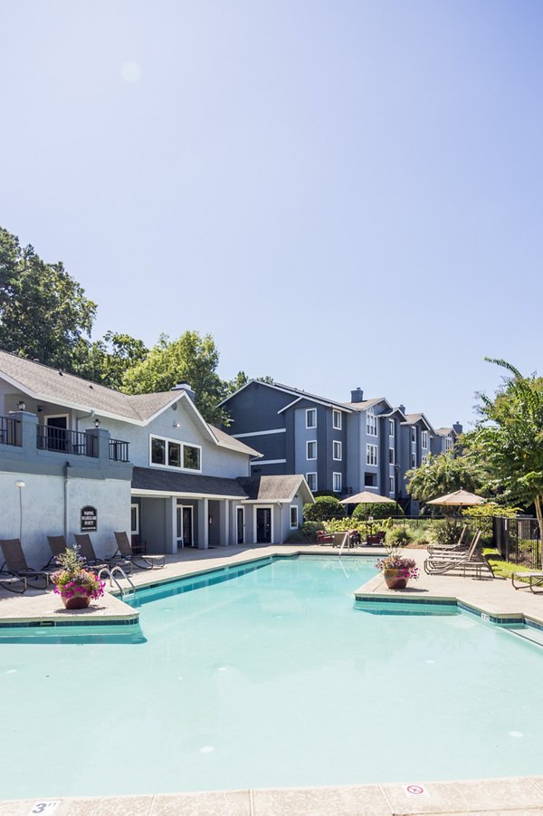 Resort-style pool with lounging areas at Aventura Dunwoody Apartments