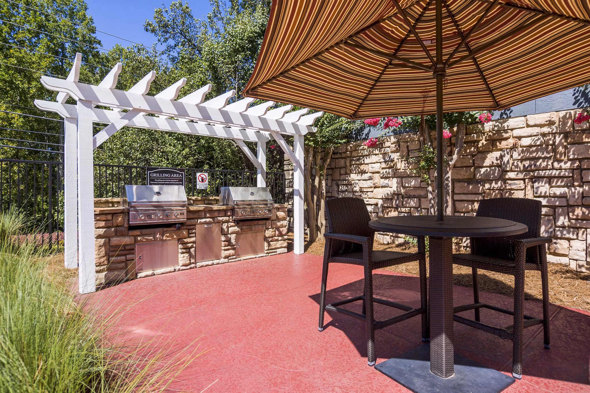 Outdoor grill area with modern seating at Aventura Dunwoody Apartments