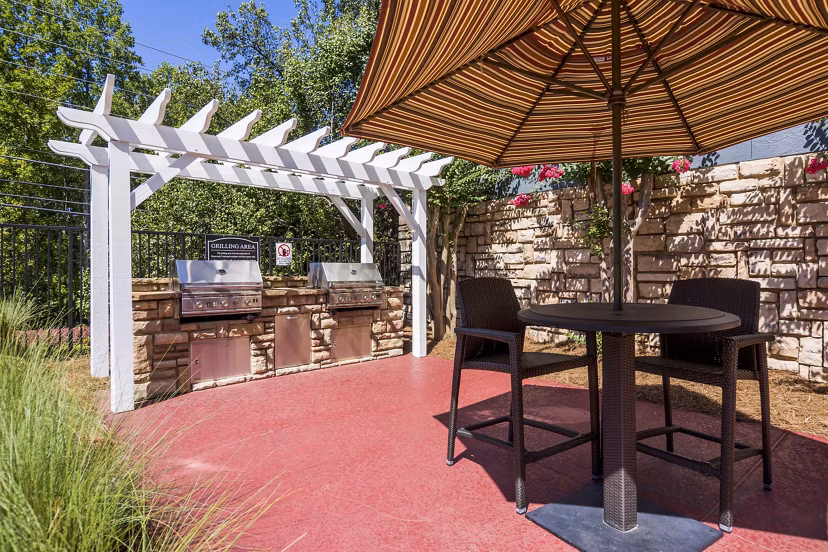Outdoor grill area with modern seating at Aventura Dunwoody Apartments