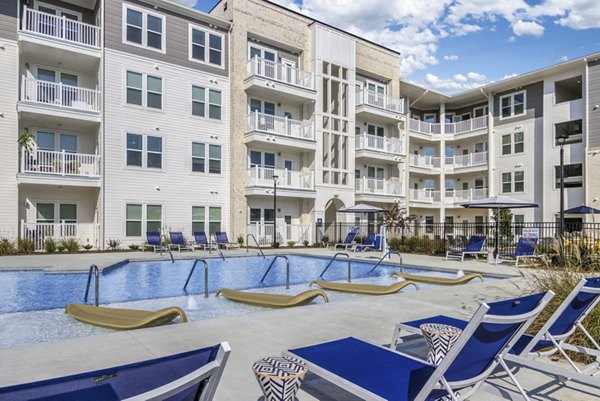 Resort-style pool with lounge seating at The Mason at Six Mile Creek Apartments