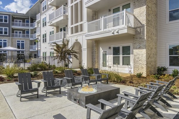 Fire pit gathering area with cozy seating at The Mason at Six Mile Creek Apartments, offering luxury outdoor amenities for residents