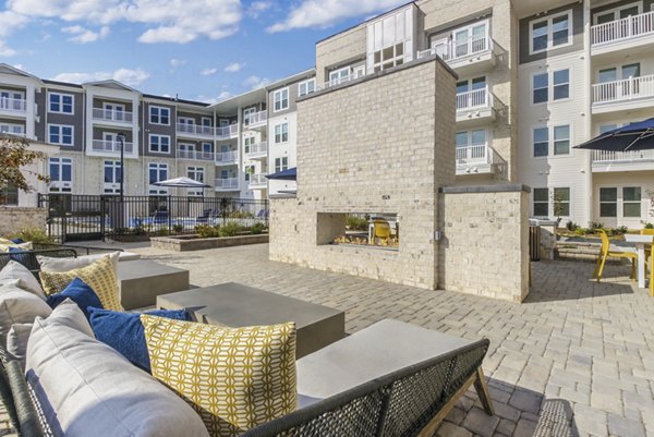 Outdoor fire pit lounge at The Mason at Six Mile Creek Apartments, offering luxury community spaces for relaxation and social gatherings