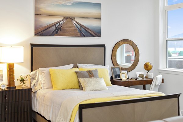 Spacious bedroom with modern furnishings in Harbor Landing Apartments