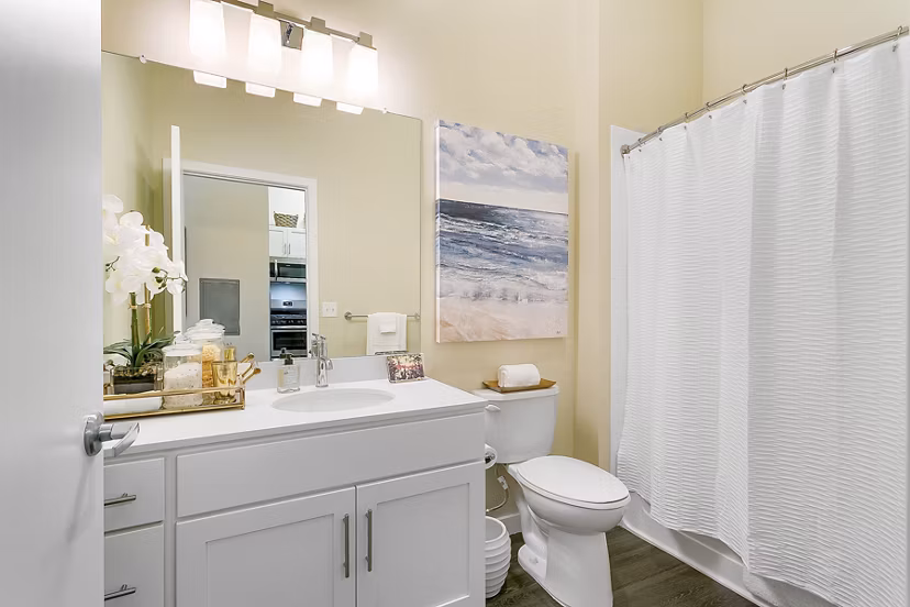 Modern bathroom with sleek fixtures and ample lighting at Harbor Landing Apartments