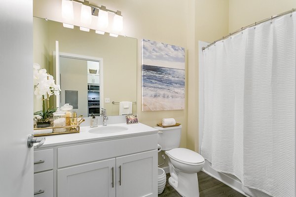 Modern bathroom with sleek fixtures and ample lighting at Harbor Landing Apartments