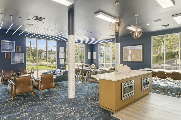 Clubhouse featuring modern design and comfortable seating at Harbor Landing Apartments in luxury Greystar community