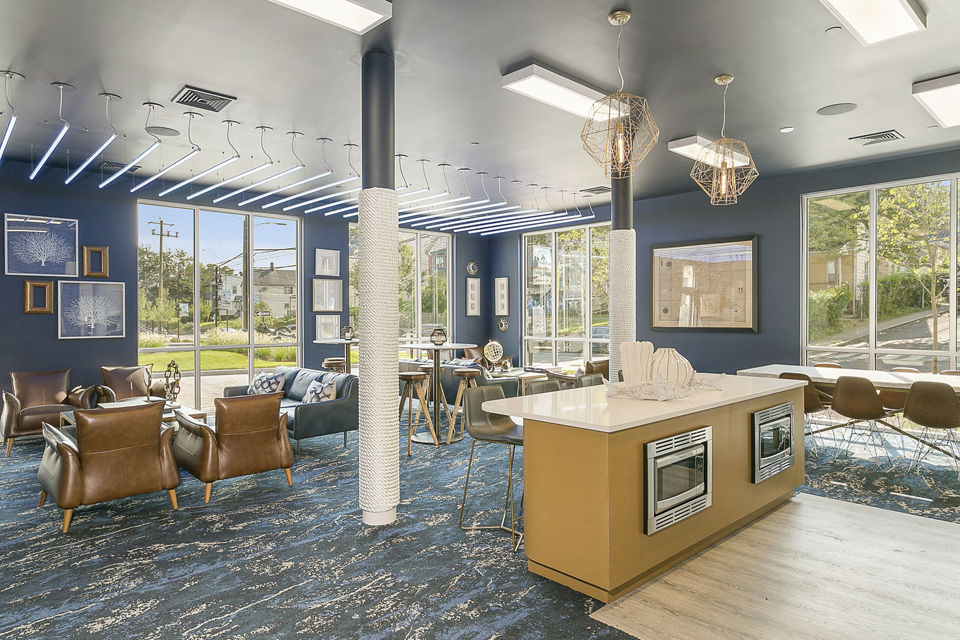 Clubhouse featuring modern design and comfortable seating at Harbor Landing Apartments in luxury Greystar community
