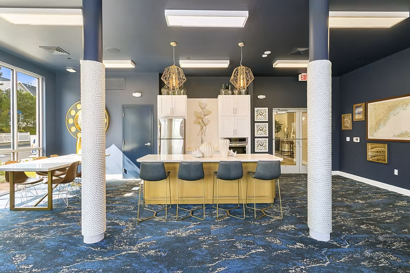 Clubhouse featuring modern design and seating areas in Harbor Landing Apartments