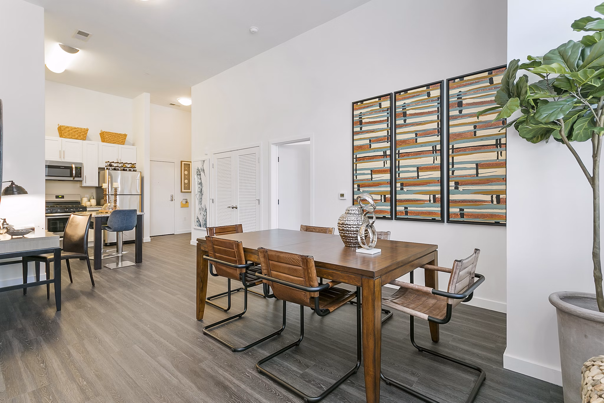 Dining area featuring modern furnishings and large windows at Harbor Landing Apartments, a luxury property managed by Greystar