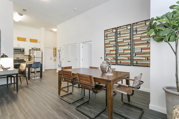 Dining area featuring modern furnishings and large windows at Harbor Landing Apartments, a luxury property managed by Greystar