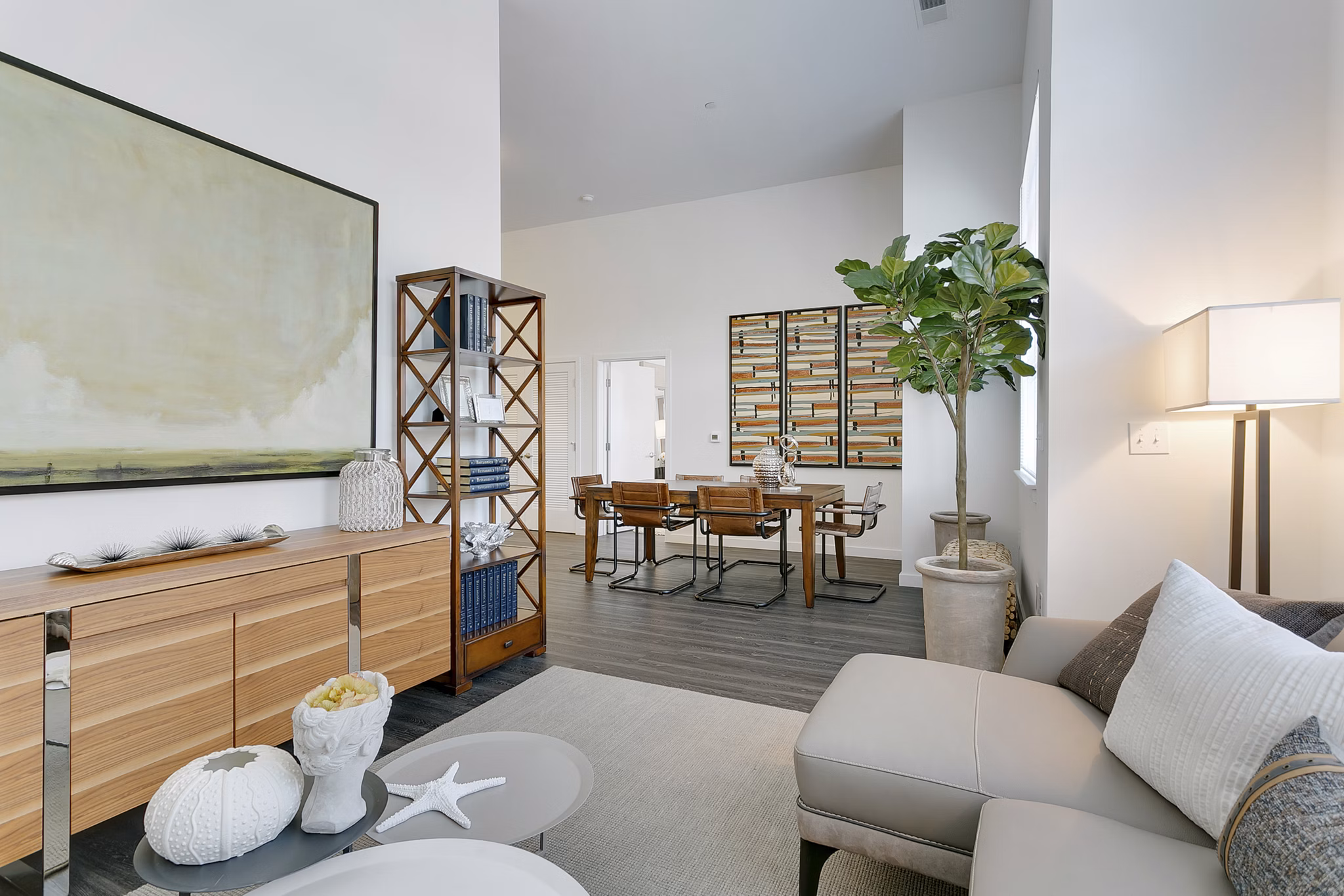 Living room with modern decor and large windows in Harbor Landing Apartments