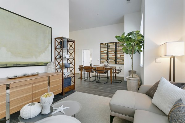 Living room with modern decor and large windows in Harbor Landing Apartments