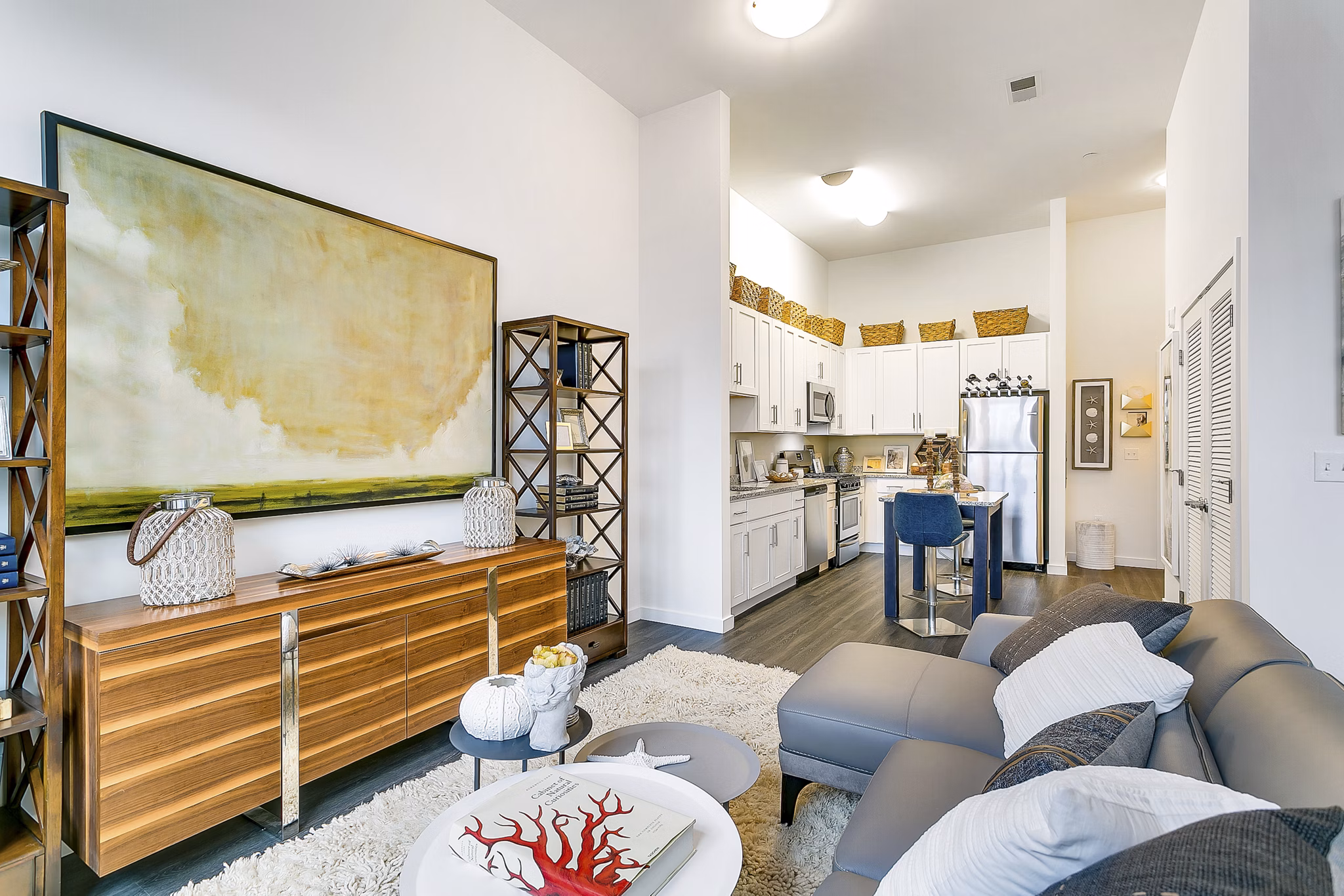 Modern living room featuring elegant furniture and large windows at Harbor Landing Apartments