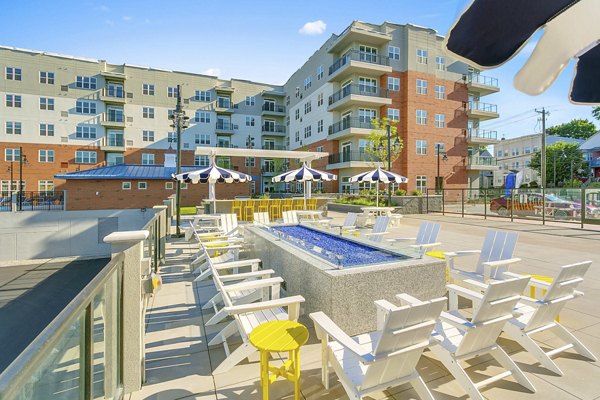 Cozy outdoor fire pit at Harbor Landing Apartments, a Greystar luxury community with stunning marina views