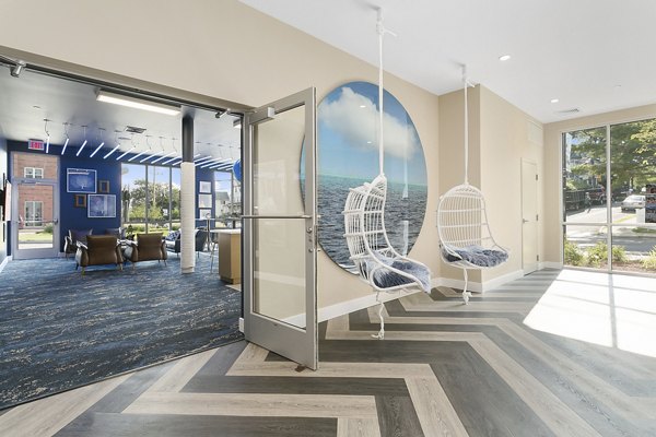Harbor Landing Apartments: Cozy patio with outdoor seating and lush greenery