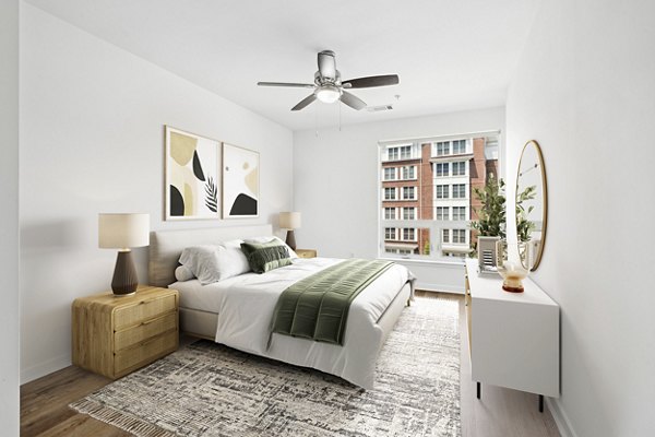 Bedroom with modern decor and ample natural light at 75 Tresser Apartments, luxury living in downtown Stamford