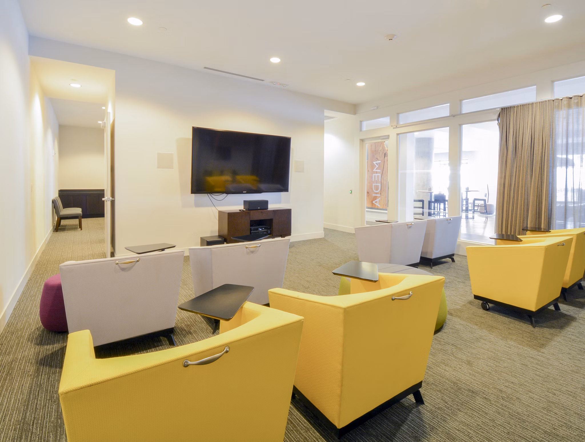 Clubhouse lounge with modern seating and entertainment area at 75 Tresser Apartments