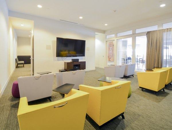 Clubhouse lounge with modern seating and entertainment area at 75 Tresser Apartments