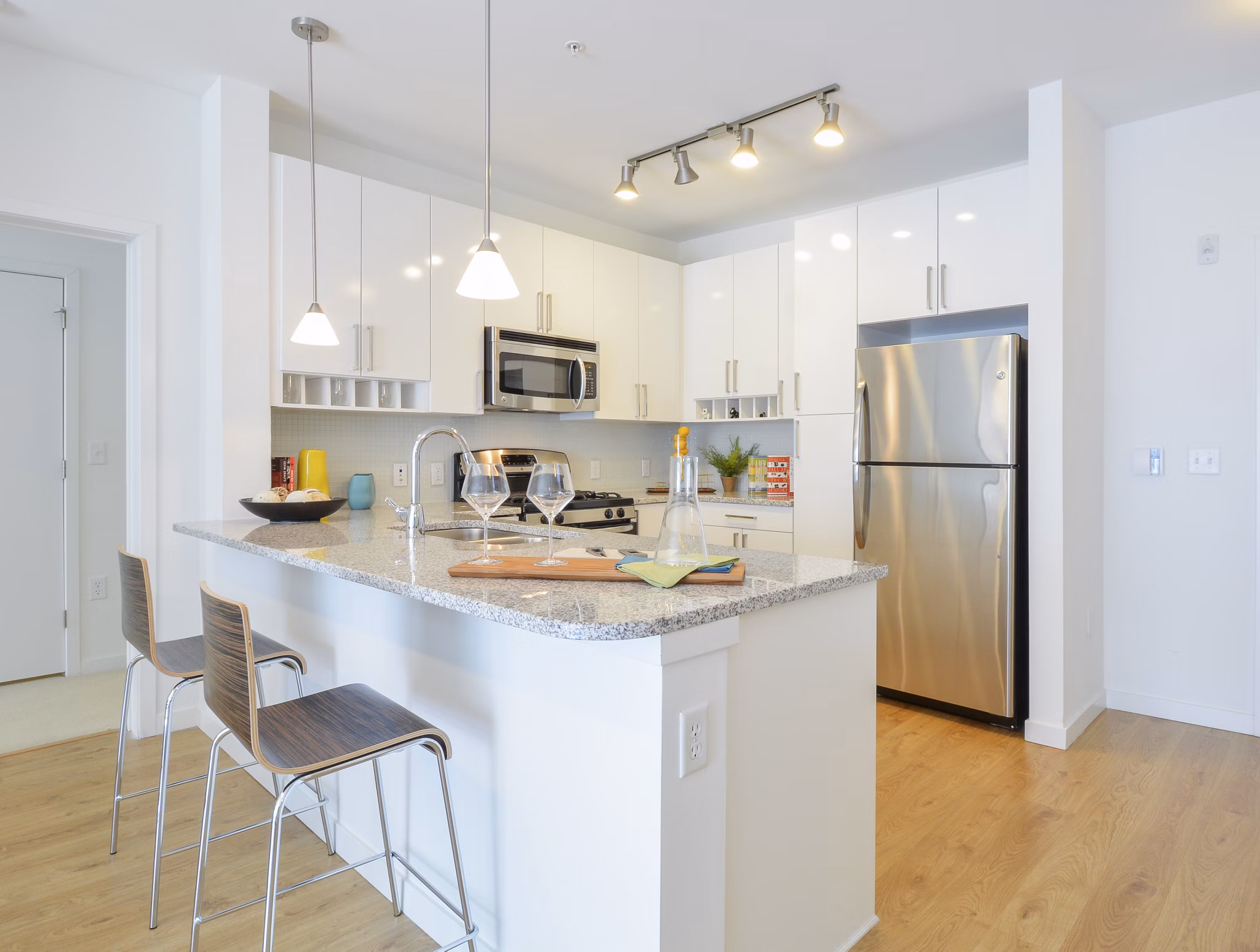 Modern kitchen featuring stainless steel appliances and granite countertops in 75 Tresser Apartments