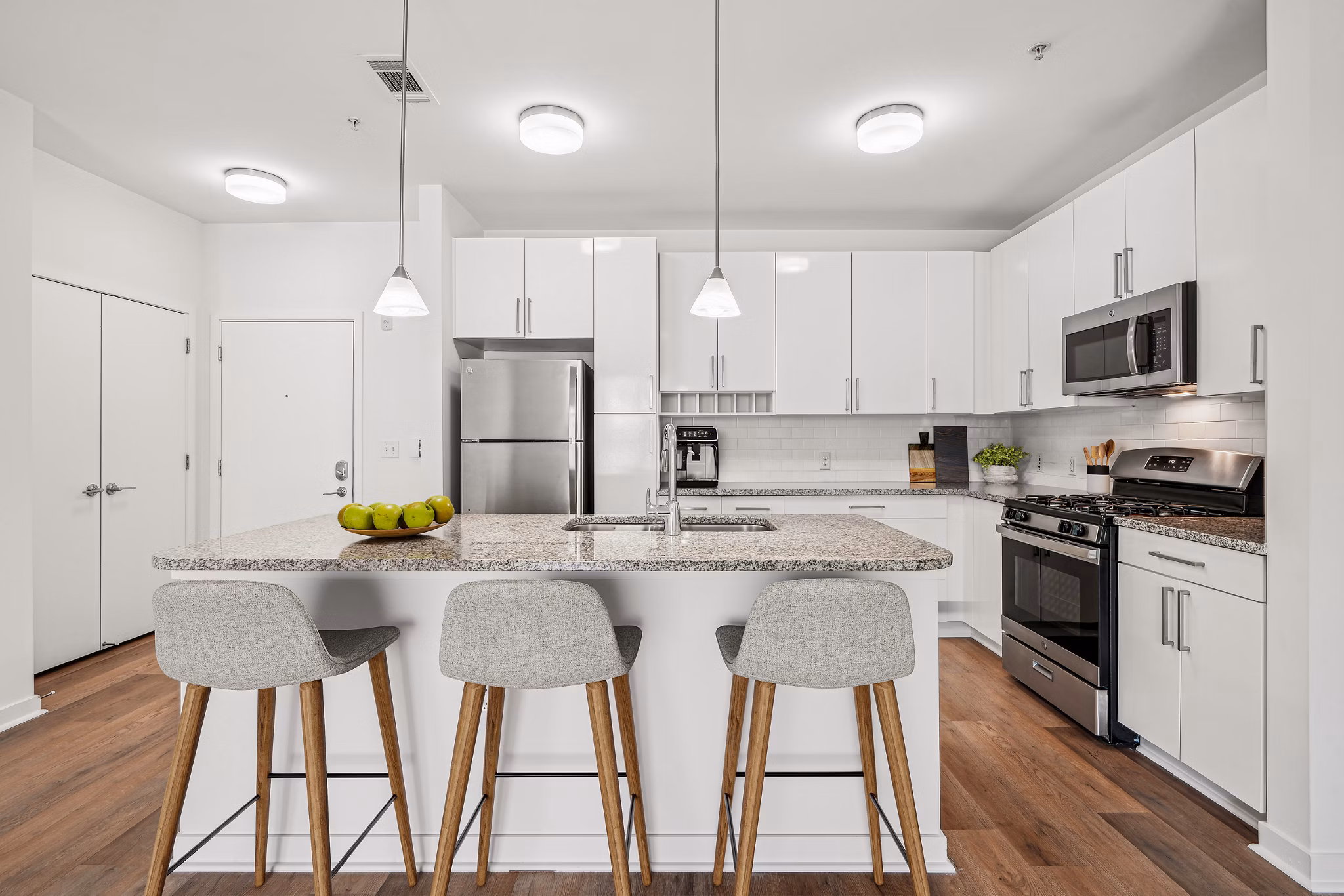 Contemporary kitchen with stainless steel appliances at 75 Tresser Apartments in Stamford, offering luxury living features