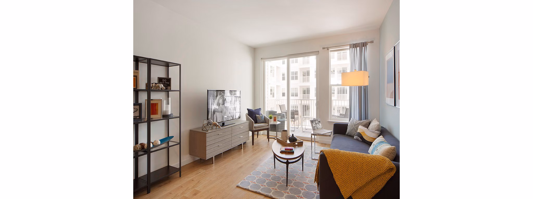 Modern living room with stylish decor and natural lighting at 75 Tresser Apartments in Greystar's luxury apartment portfolio