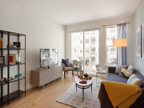 Modern living room with stylish decor and natural lighting at 75 Tresser Apartments in Greystar's luxury apartment portfolio