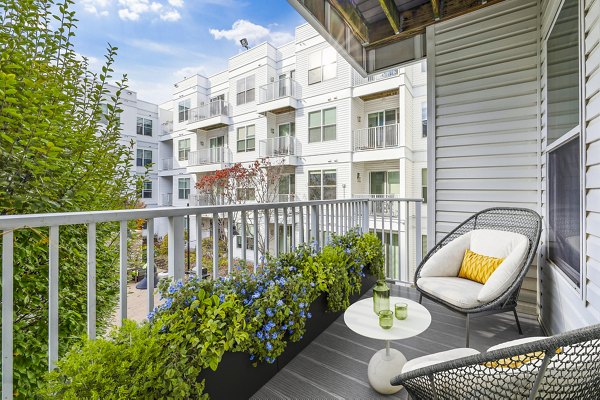 Outdoor patio/balcony with modern seating at 75 Tresser Apartments, providing relaxation space for residents in Stamford