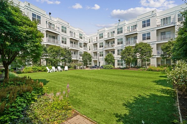 Outdoor fire pit and modern patio at 75 Tresser Apartments, offering a relaxing communal space for residents