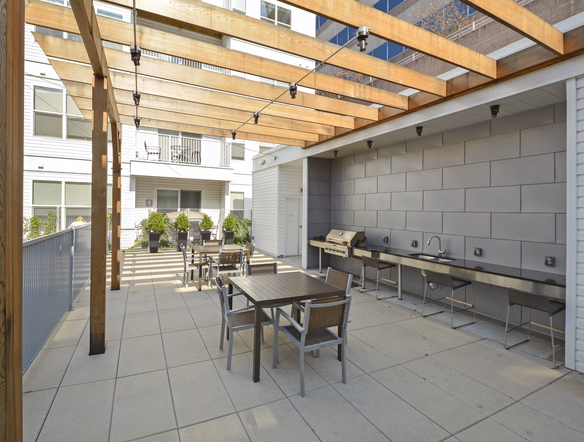 Grill area offering modern outdoor seating at 75 Tresser Apartments