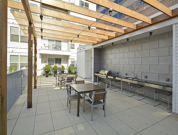 Grill area offering modern outdoor seating at 75 Tresser Apartments