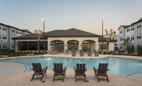 Outdoor pool with lounge seating at Prose Buda Apartments
