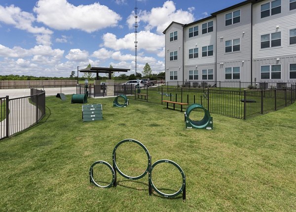 Dog park with agility equipment at Prose Buda Apartments, ideal for pet-friendly living