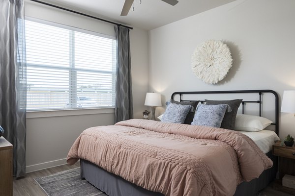 Cozy bedroom with modern design in Prose Solaire Apartments, featuring stylish furnishings and natural light