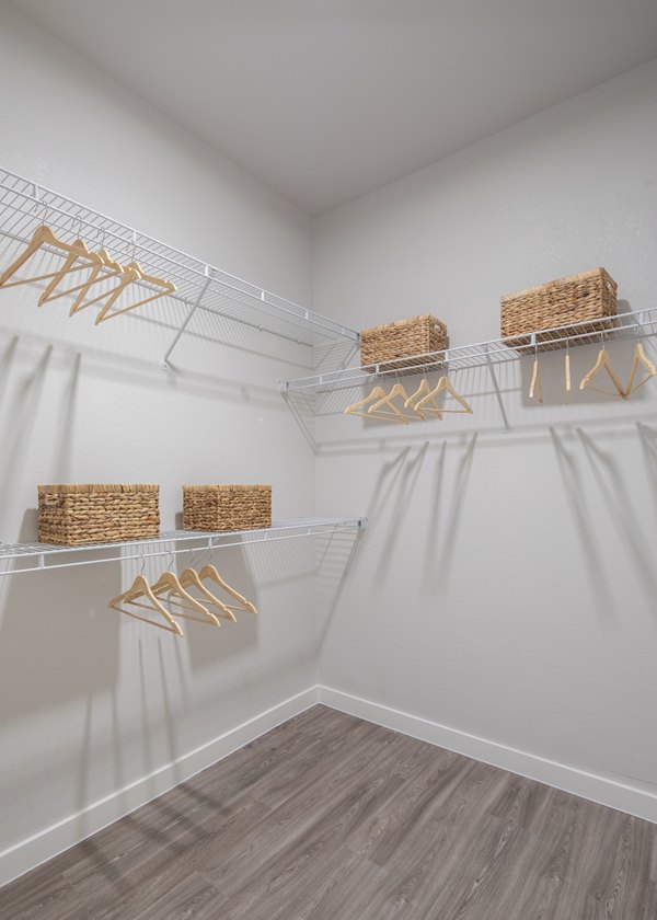 Walk-in closet with ample shelving in Prose Solaire Apartments, offering luxury living spaces