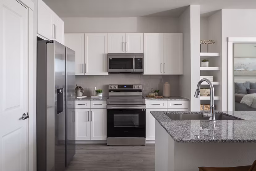 Modern kitchen with stainless steel appliances at Prose Solaire Apartments