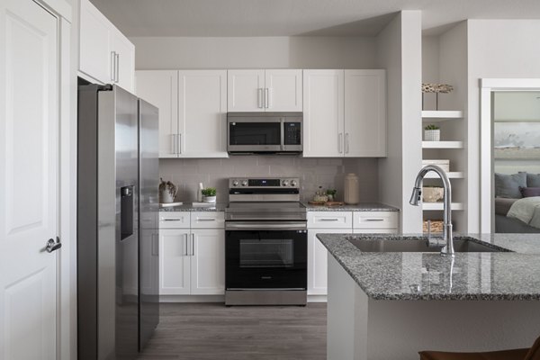 Modern kitchen with stainless steel appliances at Prose Solaire Apartments